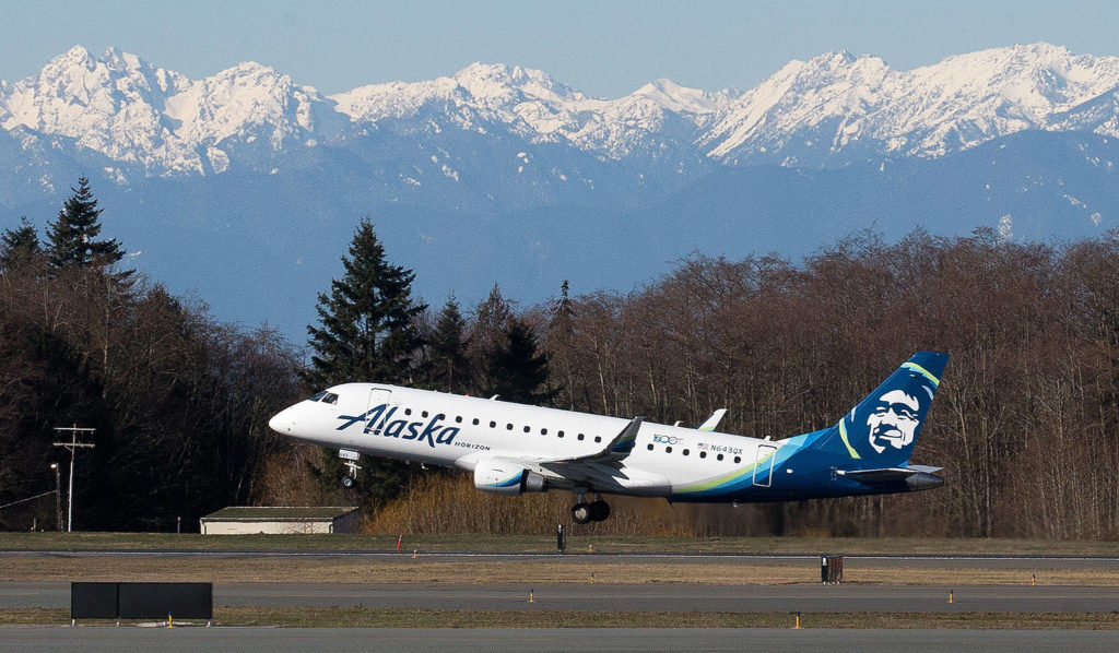 With the Olympic mountains in the background, the first passenger flight by Alaska Airlines Flight 2878 departs for Portland on opening day of the Paine Field Terminal on Monday, March 4, 2019 in Everett, Wash. (Andy Bronson / The Herald)
