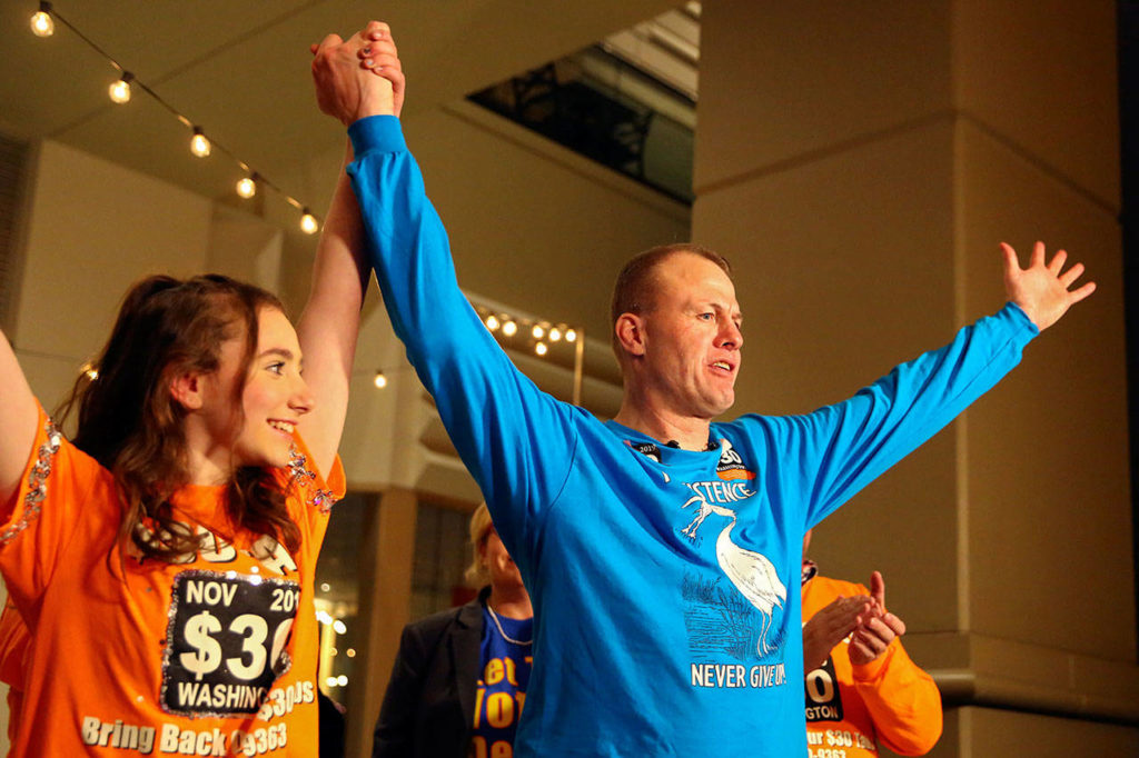 Tim Eyman declares victory with his daughter Riley Eyman (left) Tuesday evening at Hyatt Regency in Bellevue on November 5, 2019.(Kevin Clark / The Herald)