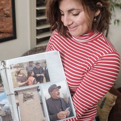 Belle Barbu, at her home in Washington, Washington County, shows photographs of some of her biological family in Romania on Tuesday, Dec. 3, 2019.