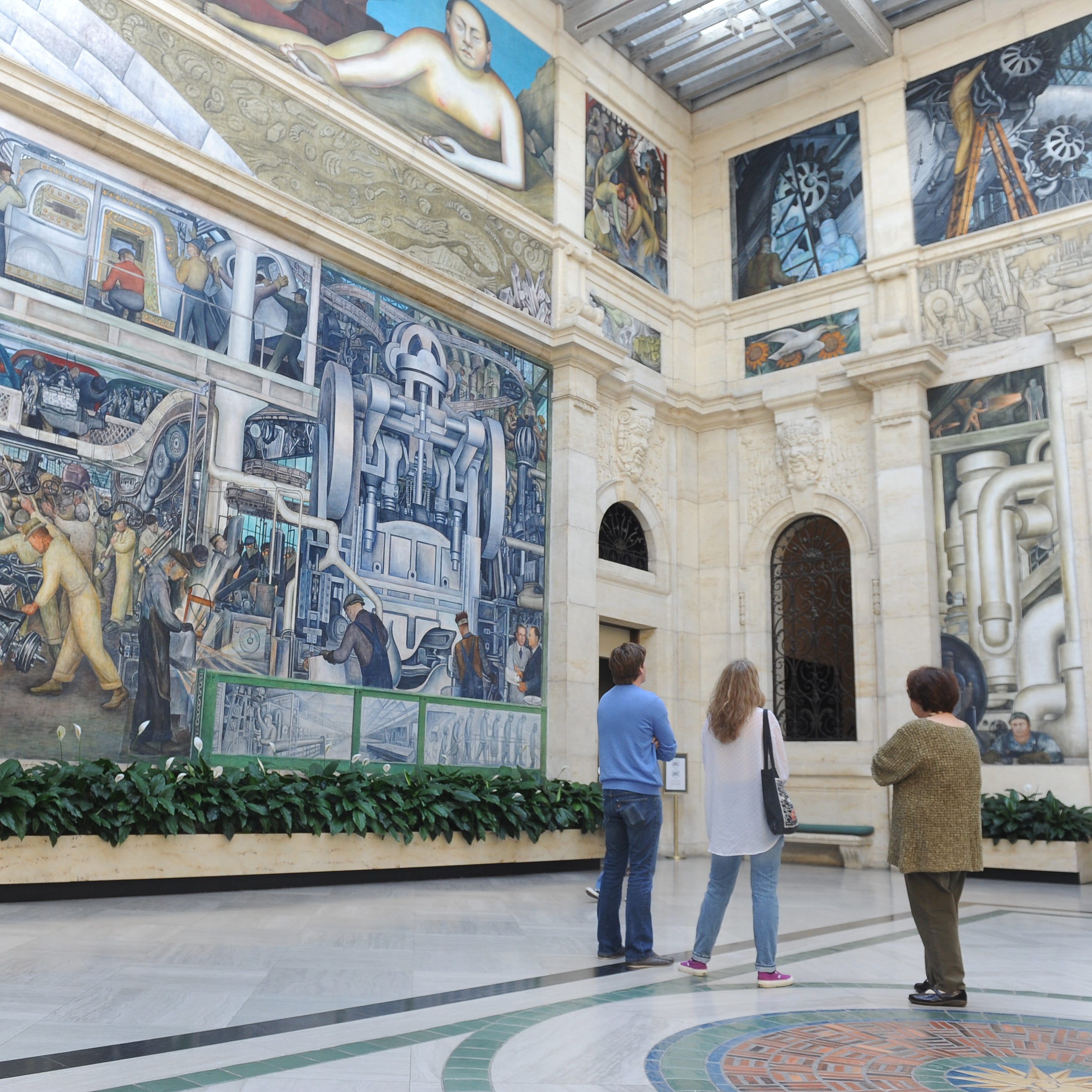 Visitors view Diego Rivera's Detroit Industry Murals at the DIA.