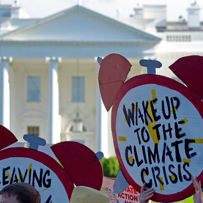 In this June 1, 2017 file photo, protesters gather outside the White House in Washington to protest President Donald Trump's decision to withdraw the United States from the Paris climate change accord. For more than two years President Trump has talked about pulling the United States out of the landmark Paris climate agreement. Starting Monday, he can finally do something about it.