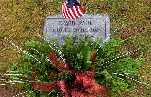 (Dave Zajac/Record-Journal via AP). In this Wednesday, Jan. 4, 2017 photo, a wreath adorns the grave of infant David Paul during an annual memorial service at Walnut Grove Cemetery in Meriden, Conn. DNA testing has helped police identify the mother of ...