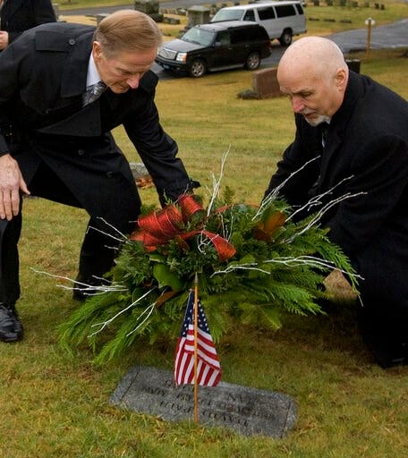 (Dave Zajac/Record-Journal via AP). In this Wednesday, Jan. 4, 2017 photo, retired Police Chief Robert E. Kosienski, left, and Keith McCurdy, a Detective Sgt. in 1988, lay a wreath at the grave of infant David Paul during an annual memorial service at ...