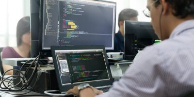 a software developer writing code on a screen