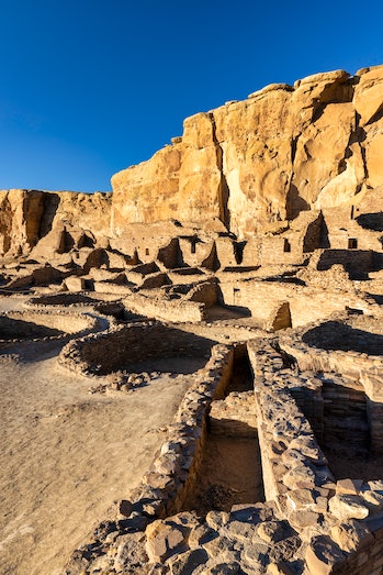 The largest of the great houses in Chaco Canyon, Pueblo Bonito is lit up by the late afternoon sun.